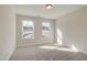 Sunlit bedroom featuring neutral carpet and a pair of windows at 4671 Larkfield Way, Powder Springs, GA 30127