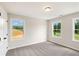 Bedroom with two windows, closet, neutral paint and carpet flooring at 4671 Larkfield Way, Powder Springs, GA 30127