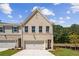 Charming new construction townhouse with a brick facade, well-manicured lawn, and attached garage at 4671 Larkfield Way, Powder Springs, GA 30127