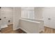 Upstairs hallway with railing, laundry area with hookups, and linen closet at 4671 Larkfield Way, Powder Springs, GA 30127