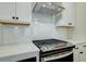 A close-up of the kitchen showcasing the backsplash and oven at 4671 Larkfield Way, Powder Springs, GA 30127