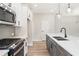 Modern kitchen with white cabinets, a gray island, stainless steel appliances, and laminate floors at 4671 Larkfield Way, Powder Springs, GA 30127