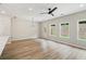 Open floor plan featuring laminate floors and bright, naturally lit living area with modern lighting at 4671 Larkfield Way, Powder Springs, GA 30127