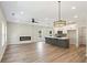 Spacious living room with fireplace, ceiling fan and an island with modern lighting at 4671 Larkfield Way, Powder Springs, GA 30127