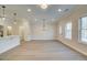 A brightly lit living space with an island kitchen and large windows at 4671 Larkfield Way, Powder Springs, GA 30127