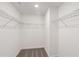 Empty walk-in closet featuring wire shelving, neutral color, and carpet flooring at 4671 Larkfield Way, Powder Springs, GA 30127