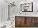 This bathroom features a wood vanity, a commode, and a tile shower behind a white curtain at 2638 Vinings Central Se Dr # 4, Atlanta, GA 30339