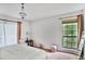 The bedroom includes a comfortable bed, a window view, a decorative chandelier, and stylish decor at 2638 Vinings Central Se Dr # 4, Atlanta, GA 30339
