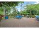 Large wooden deck area with table and chairs, grills and outdoor seating surrounded by trees at 2638 Vinings Central Se Dr # 4, Atlanta, GA 30339