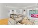 Bright living room features a modern couch, hardwood floors, and white walls at 2638 Vinings Central Se Dr # 4, Atlanta, GA 30339