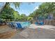 Community pool area featuring a waterfall, outdoor seating, lounge chairs, and lush landscaping at 2638 Vinings Central Se Dr # 4, Atlanta, GA 30339