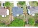 Aerial view of home with fenced backyard and mature trees at 3880 Lake Lanier Dr, Duluth, GA 30097