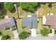 Aerial view of the home featuring a gray roof, landscaped yard, and a driveway leading to the street at 3880 Lake Lanier Dr, Duluth, GA 30097