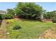Large backyard featuring mature trees and partial fencing at 3880 Lake Lanier Dr, Duluth, GA 30097