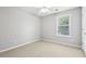 Bright bedroom with a ceiling fan and natural light from a large window at 3880 Lake Lanier Dr, Duluth, GA 30097