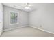 Neutral bedroom featuring carpet, ceiling fan and window at 3880 Lake Lanier Dr, Duluth, GA 30097