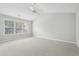 A bedroom shows large windows for ample light, carpeting, and neutral walls at 3880 Lake Lanier Dr, Duluth, GA 30097