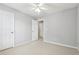 Cozy bedroom with carpet, ceiling fan, and an open closet at 3880 Lake Lanier Dr, Duluth, GA 30097