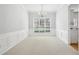Bright dining room featuring large windows, white wainscoting, neutral carpet, and a chandelier at 3880 Lake Lanier Dr, Duluth, GA 30097