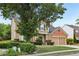 Two-story home with brick accents, a well-maintained lawn, and mature trees at 3880 Lake Lanier Dr, Duluth, GA 30097