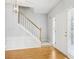 Bright foyer with hardwood floors, a staircase, and a front door with sidelights, offering a welcoming entrance at 3880 Lake Lanier Dr, Duluth, GA 30097