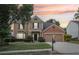 Inviting two-story home with a brick facade, manicured landscaping, and a spacious driveway at 3880 Lake Lanier Dr, Duluth, GA 30097