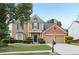 Charming two-story home with a well-manicured lawn and a two-car garage, exuding curb appeal at 3880 Lake Lanier Dr, Duluth, GA 30097