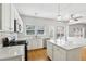 Well-lit kitchen features white cabinets, quartz countertops, stainless appliances and breakfast bar at 3880 Lake Lanier Dr, Duluth, GA 30097