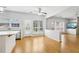 Sun-filled kitchen with white cabinets, quartz countertops, stainless appliances and breakfast bar at 3880 Lake Lanier Dr, Duluth, GA 30097