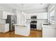 Bright kitchen features white cabinets, stainless-steel appliances, and a center island at 3880 Lake Lanier Dr, Duluth, GA 30097