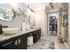 This stylish bathroom features dual sinks with granite countertops and a walk-in closet and glass enclosed shower at 507 Southshore Ln, Dallas, GA 30157