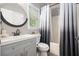 Stylish bathroom with a vanity, modern fixtures, and a shower/tub combo with an ombre curtain at 507 Southshore Ln, Dallas, GA 30157