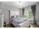 Bright bedroom with hardwood floors, large windows, a comfortable bed, and decorative chandelier at 507 Southshore Ln, Dallas, GA 30157