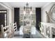 Sophisticated dining room featuring a glass table, seating for six, a decorative mirror, and a modern chandelier at 507 Southshore Ln, Dallas, GA 30157