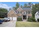 Charming two-story brick home featuring manicured landscaping and a three-car garage at 507 Southshore Ln, Dallas, GA 30157