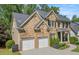 Brick two-story home features a two-car garage and professionally landscaped yard at 507 Southshore Ln, Dallas, GA 30157