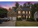 Beautiful brick home with a manicured lawn, mature trees, and a driveway leading to a two-car garage at 507 Southshore Ln, Dallas, GA 30157
