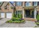 Elegant brick home with a manicured lawn, a two-car garage, and a welcoming front porch at 507 Southshore Ln, Dallas, GA 30157