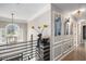 Bright hallway with modern art, stylish lighting fixtures, decorative accents, and hardwood floors at 507 Southshore Ln, Dallas, GA 30157