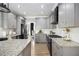 Well-appointed kitchen featuring gray cabinets, granite countertops, and modern appliances at 507 Southshore Ln, Dallas, GA 30157