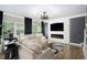 Comfortable living room with a fireplace, modern lighting, and neutral color palette at 507 Southshore Ln, Dallas, GA 30157