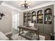 Study featuring built-in bookshelves, unique decor, and a statement chandelier at 507 Southshore Ln, Dallas, GA 30157