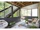 Inviting screened-in porch features a cozy egg chair and outdoor seating, perfect for relaxation at 507 Southshore Ln, Dallas, GA 30157