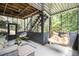 Relaxing screened porch with hanging chair and comfortable seating, ideal for enjoying the outdoors at 507 Southshore Ln, Dallas, GA 30157