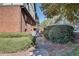 Exterior view of the back of the home showing a walkway with manicured bushes at 6851 Roswell Rd # H1, Sandy Springs, GA 30328