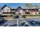 Townhouse exterior featuring brick, landscaping, and visible parking at 6851 Roswell Rd # H1, Sandy Springs, GA 30328