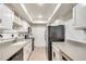 Efficient kitchen features white cabinets, updated appliances, and ample counter space at 6851 Roswell Rd # H1, Sandy Springs, GA 30328