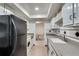 Galley style kitchen with appliances and doorway to dining area at 6851 Roswell Rd # H1, Sandy Springs, GA 30328