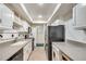 Well-lit kitchen features white cabinets, updated appliances, and functional design at 6851 Roswell Rd # H1, Sandy Springs, GA 30328