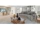 Bright living room featuring a large grey couch, decorative bookshelf, and an adjacent dining area at 6851 Roswell Rd # H1, Sandy Springs, GA 30328